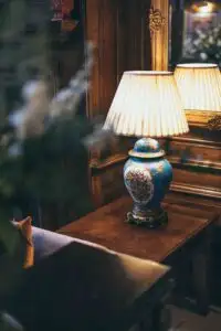 Elegant interior at Rowton Castle featuring a traditional table lamp, wooden panelling, and classic décor