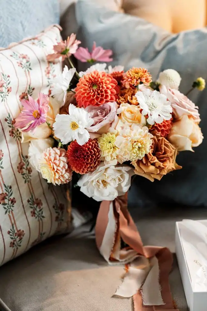 Wedding bouquet resting on a sofa during bridal preparations
