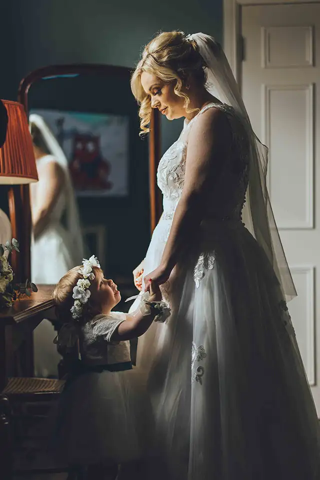 Bride admiring her wedding dress before getting ready
