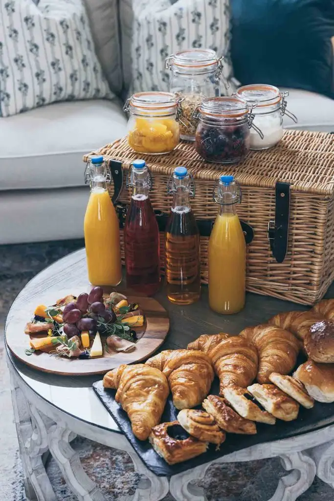Continental breakfast spread with pastries, fruit and juices