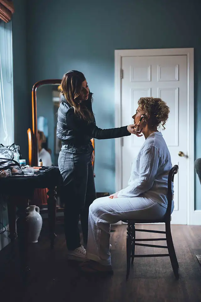 Hair and makeup being applied on the wedding morning