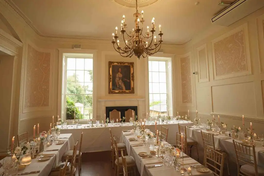 Elegant wedding reception setup with chandelier and banquet tables at Rowton Castle