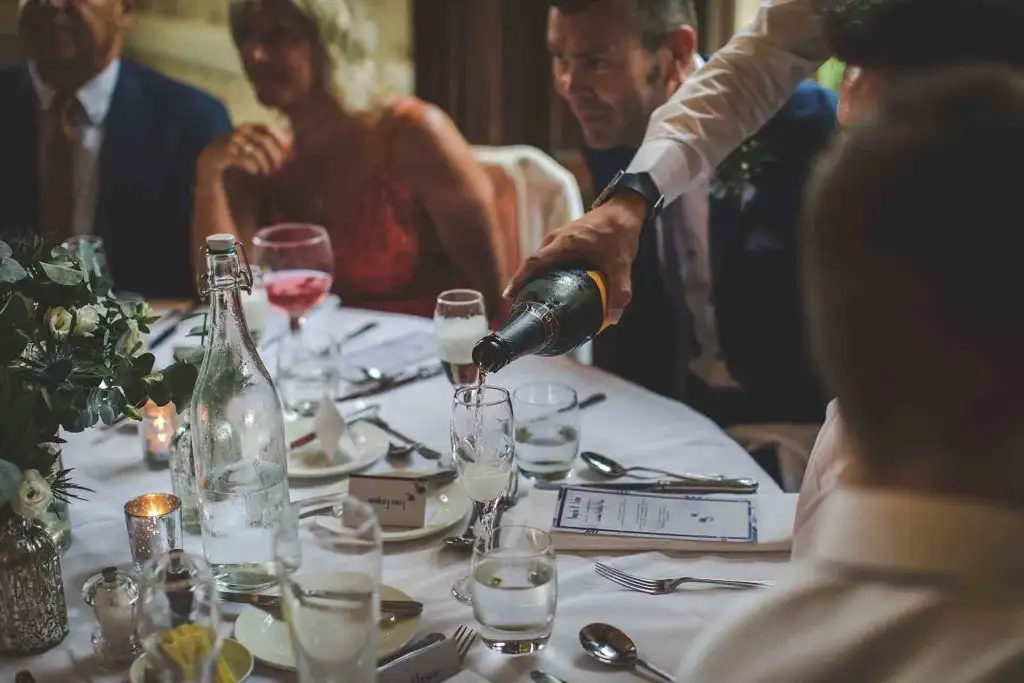 Champagne being poured for guests during a wedding reception at Rowton Castle