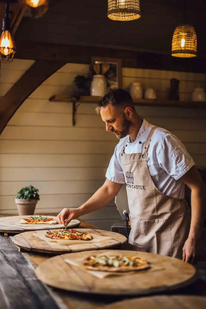 Rowton Castle chef preparing fresh wood-fired pizzas for wedding evening food