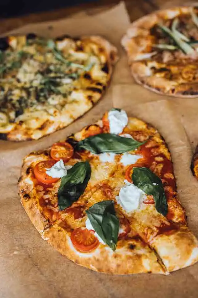 Fresh wood-fired pizza with basil, mozzarella and tomatoes served at Rowton Castle wedding