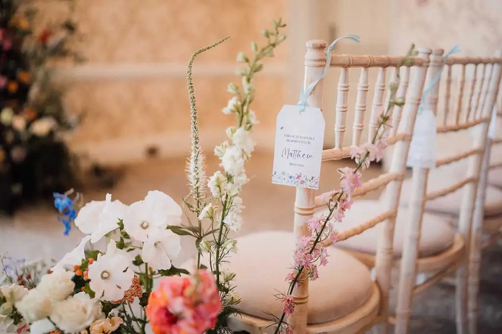 Wedding ceremony chair decoration with flowers and reserved seat tag at Rowton Castle