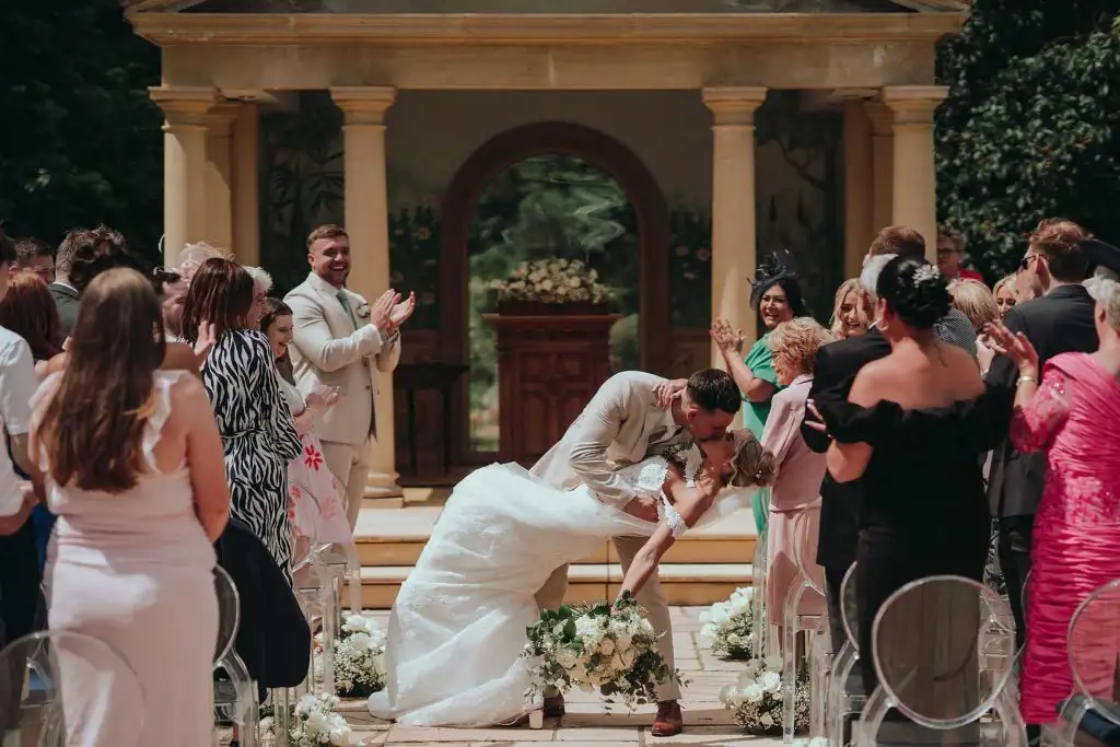 Bride and groom sharing their first kiss at the Rowton Castle outdoor temple ceremony